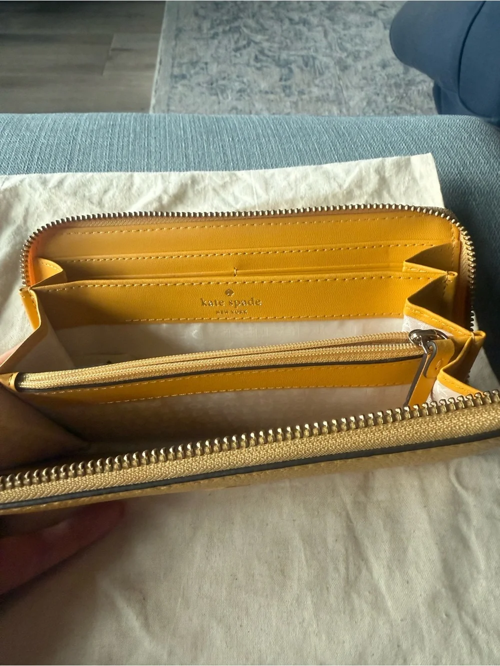 kate spade New York yellow zip-around pebbled leather wallet